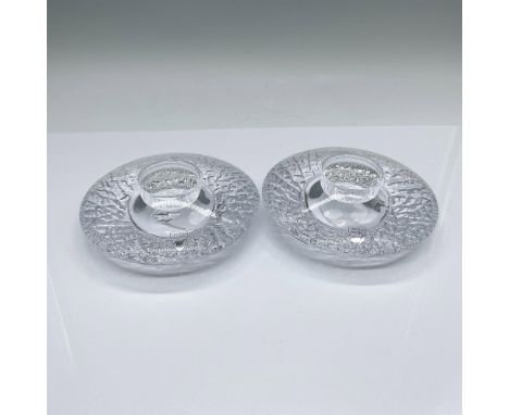 A set of 2 votive candleholders designed by Lars Hellsten. A textured underside with a clear smooth top. Orrefors marked. Thi