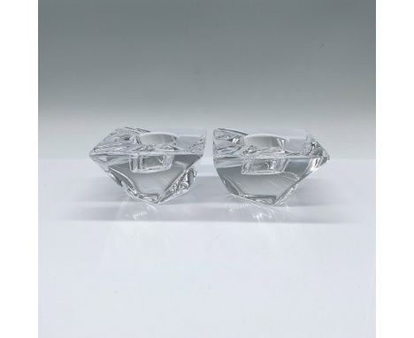 A set of 2 clear square votive candleholder with a twist. Orrefors marked. Issued: c. 2003-2016Dimensions: 4"L x 4"W x 2.25"H
