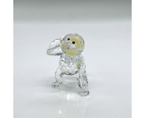 Sparkling clear faceted crystal figure of a young gorilla walking carrying a bunch of frosted yellow bananas. Swarovski mark.