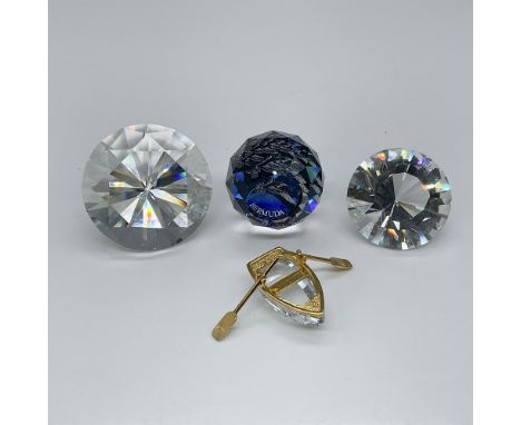 Crystal grouping featuring two clear faceted chaton's, a globe paperweight with a bird on a blue background, and a crystal me