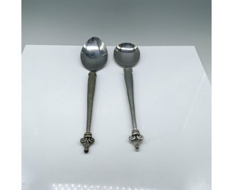 Two large silver-colored serving spoons, one with a round bowl and the other with an oval bowl. Marked C Boyes. Dimensions of