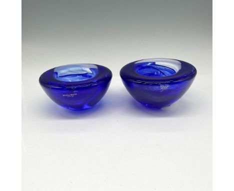 Created with cobalt blue glass with light swirls within. Kosta Boda mark. One item has its original box: 5"L x 4.5"W x 3"H. A