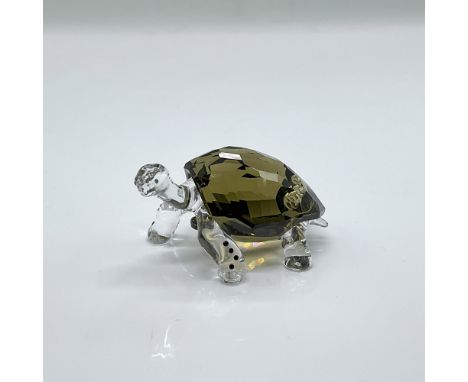 Clear and smoky quartz faceted crystal figure of a long neck tortoise. Event piece for 2010. Swarovski mark. This item has it