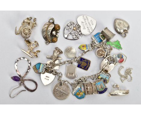 A CHARM BRACELET, LOOSE CHARMS AND PENDANTS, the charm bracelet fitted with various enamel shield charms, two coins, a windmi