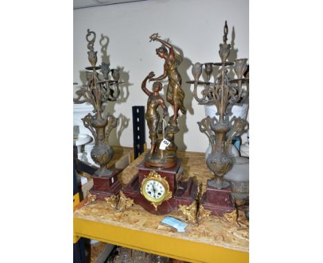 AN EARLY 20TH CENTURY BRONZED SPELTER AND ROUGE MARBLE CLOCK GARNITURE, the clock with figural surmount titled 'La Gloire Cou