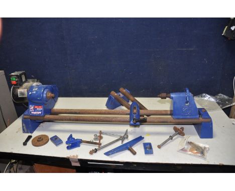 A RECORD POWER DML24X WOOD TURNING LATHE with extension bars, face plate and spare centre and long boring tool