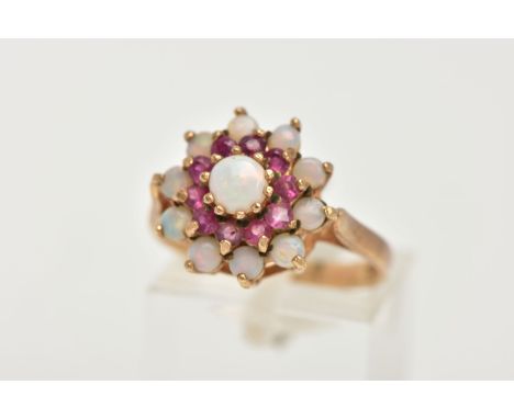 A 9CT GOLD RUBY AND OPAL CLUSTER RING, tiered cluster set with a central circular opal cabochon to a surround of circular cut