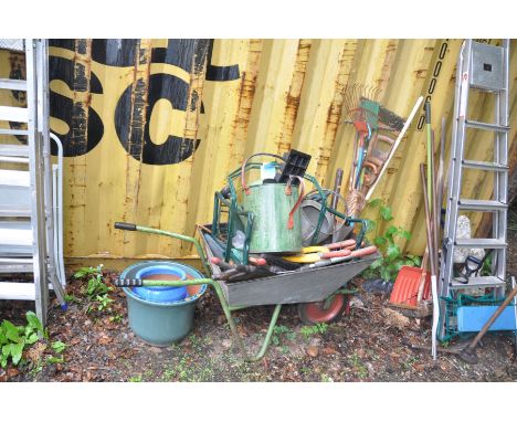 THREE GLAZED PLANT POTS AND A WHEELBARROW containing a quantity of garden tools