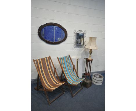A PAIR OF 1970'S FOLDING DECK CHAIRS, with stripped fabric, an early 20th century oak bevelled edge wall mirror, two other mi