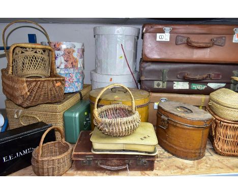A QUANTITY OF VINTAGE LUGGAGE, BASKETS, ETC, to include four brown vintage suitcases, most with travel labels, two tin hat ca