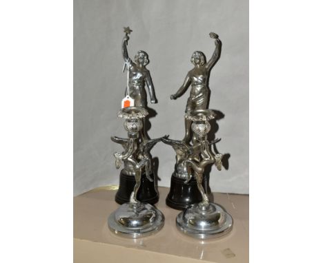 A PAIR OF ART DECO CHROME FIGURES, with a pair of Art Deco chrome candle holders, the chrome figures each standing on bakelit