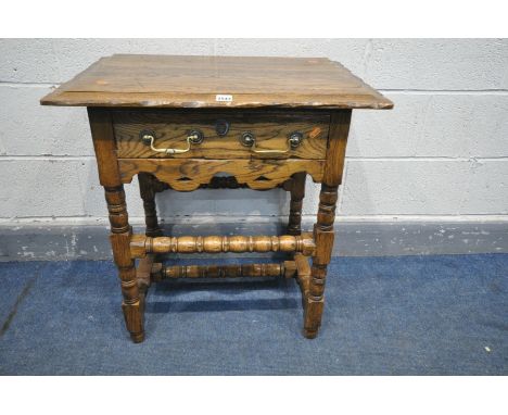 A REPRODUCTION OAK SIDE TABLE WITH A SINGLE DRAWER, on bobbin turned legs, united by turned stretchers, width 69cm x depth 46