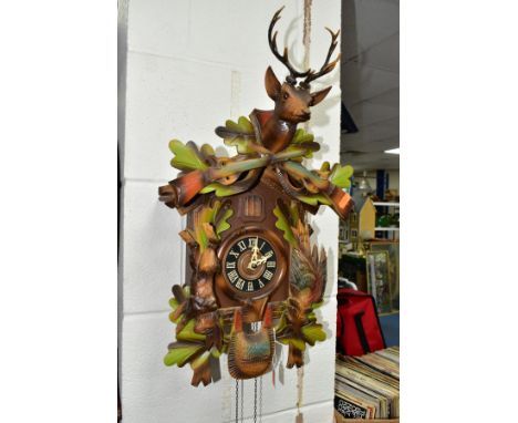 A LATE 20TH CENTURY GERMAN CUCKOO CLOCK, with pendulum and weights, movement in need of restoration, approximate height 58cm