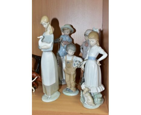 FIVE NAO PORCELAIN FIGURINES, comprising a girl with a hoop, two children with puppies, a boy with a football, and a girl hol