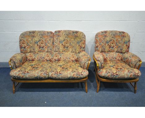 AN ERCOL ELM WINDSOR JUBILEE TWO PIECE LOUNGE SUITE, comprising of a two seater sofa and an arm chair, with floral upholstery