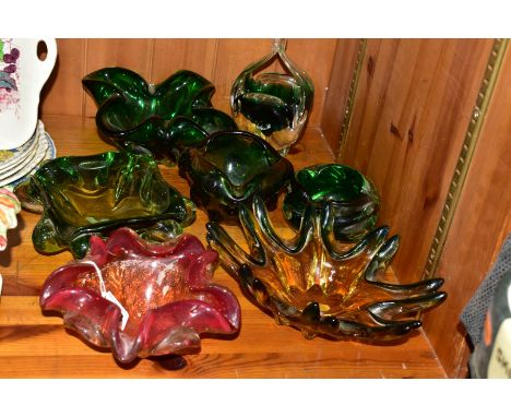 SIX MURANO STYLE COLOURED GLASS BOWLS AND A PRESS MOULDED GREEN GLASS BOWL, including a red, orange and clear wavy rimmed bow