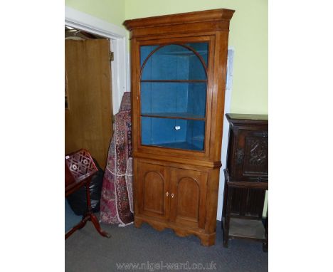 A medium light oak finish Corner Cabinet over Cupboard, the upper portion with a glazed door with arched pattern beading. The