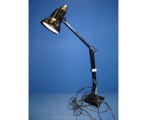 A black angle poise lamp.
