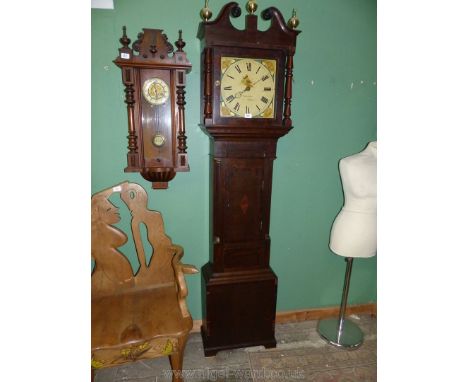 An Oak cross banded with Rosewood cased Longcase Clock having scroll pediment with three turned brass finials. The central se