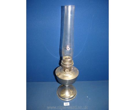 A metal base Oil lamp with clear chimney, 23" high.