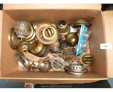 A small quantity of oil lamp parts including wicks, brass fittings, etc.