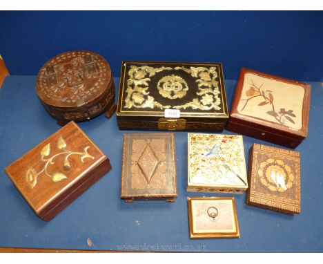 A quantity of oriental boxes including ream with painted detail, brass flower detail, circular wooden box with lock, black an