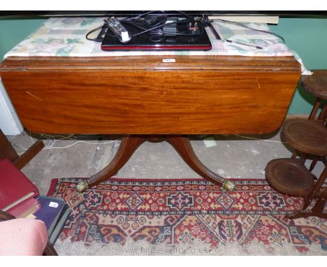 A fine quality Mahogany 19th c. drop-leaf table having a drawer to the end with drop ring handles, standing on a turned pilla