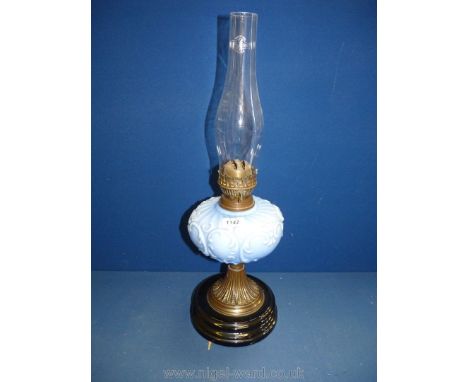 A Victorian brass oil Lamp with blue opaque reservoir, on black base, with chimney, 22'' tall overall.