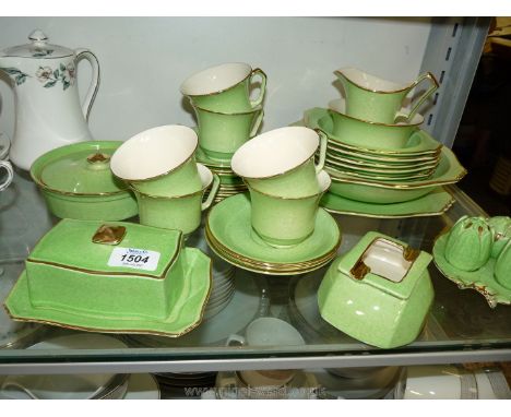 A quantity of Royal Winton 'Grimwade' part tea and dessert set in pea green: cups, saucers, butter dish, cruet, fruit bowls e