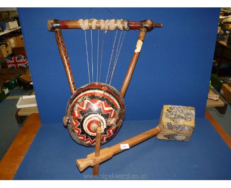 Two ethnic musical instruments:  Ethiopian Masinqo and Kenyan yoke lute.