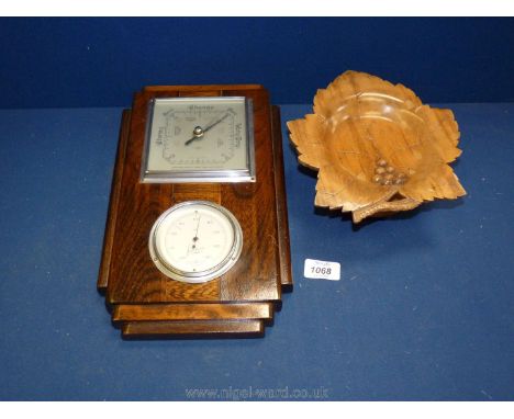 A wooden framed wall barometer/thermometer and a treen musical sweet plate.