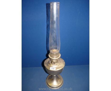 A vintage nickel plated Aladdin oil lamp with glass chimney, 23 3/4'' tall.
