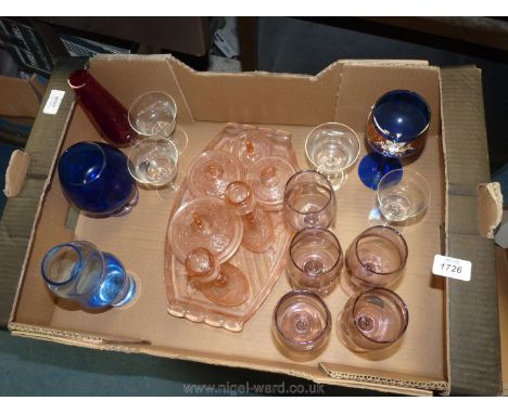 A quantity of coloured glass including a Dartington Crystal blue vase, pink dressing table set, blue goblet, glasses etc.