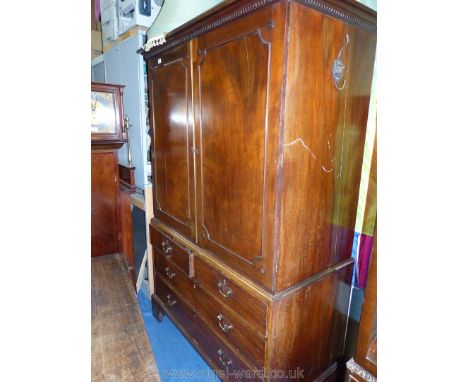 A 19th c. Mahogany Linen Press, the opposing doors having brass beading and dentil frieze over revealing a linen slide interi