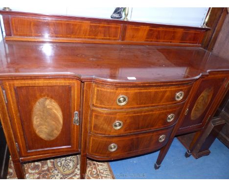 A good Edwardian Mahogany Sideboard having cross-banded and light and darkwood stringing and inlaid oval panels to the opposi