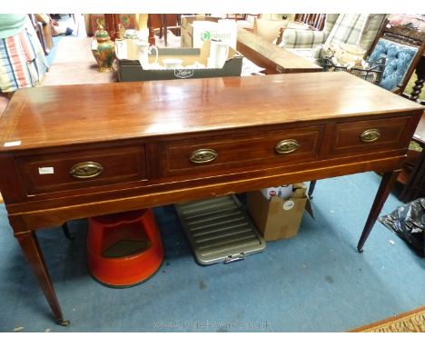 A 19th c. Mahogany Sideboard having light and darkwood stringing and three frieze drawers and standing on tapering square leg