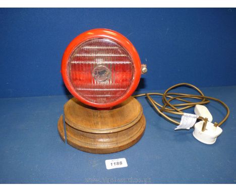 A table lamp made from a Massey Ferguson head light, with tractor logo on lens.