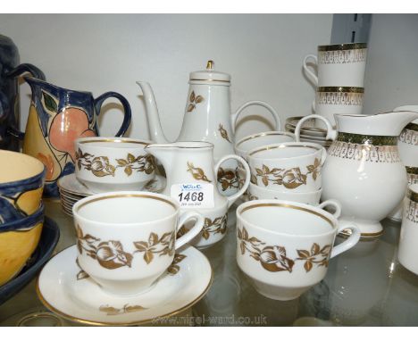 A  vintage Henneberg coffee service for six with gold coloured roses on white ground, marked 1777 to bases.