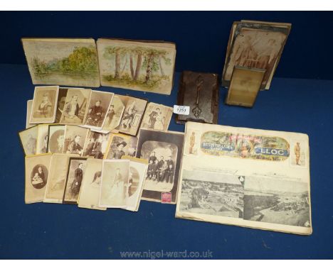 A quantity of old black and white portrait photographs, scrapbook of photographs of Africa, cigarette cards of small watercol