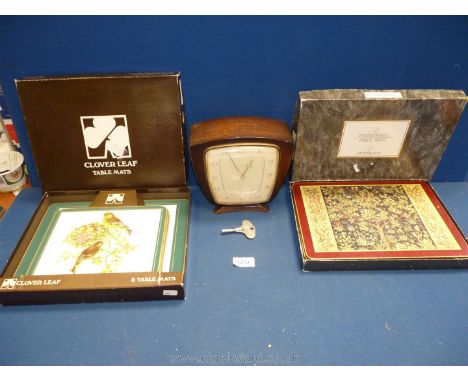 A Smiths Mantle clock with key, plus eight Cloverleaf table mats depicting birds and six Cloverleaf depicting tapestry.