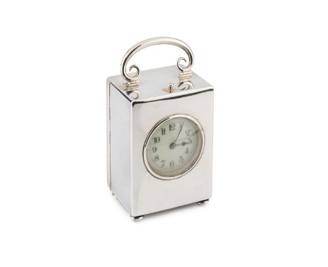 An Edwardian silver carriage clock, having circular enamel dial, the case with hinged scroll top handle and bun feet, the mov