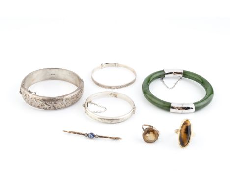 A gem set dress ring, set with an oval cabochon tiger's eye, stamped '9CT', an orange stone dress ring, a pair of opal ear st