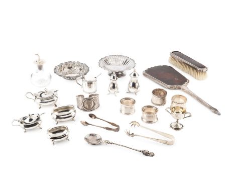 A collection of silver, comprising two small dishes, four napkin rings, eleven various small cruet items, two pairs of sugar 