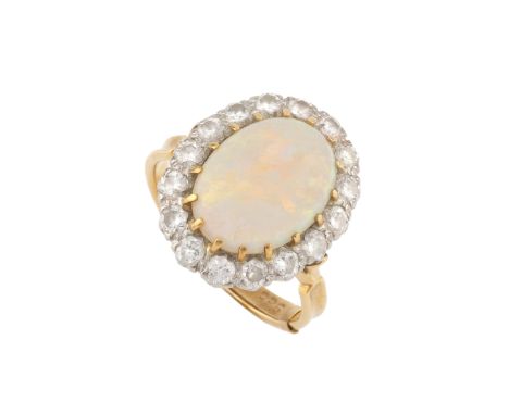 An opal and diamond cluster ring, the central oval cabochon opal claw set within a border of old-cut diamonds, stamped '18ct'