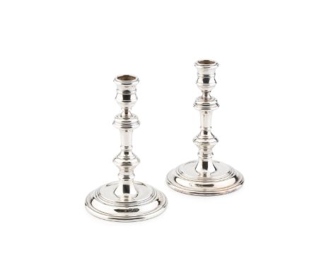 A pair of silver candlesticks, of 18th century design, with knopped stems and weighted circular bases by William Comyns &amp;