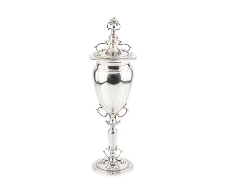 An early 20th century Dutch silver chalice and cover, of Arts &amp; Crafts design, the baluster body raised on slender pedest