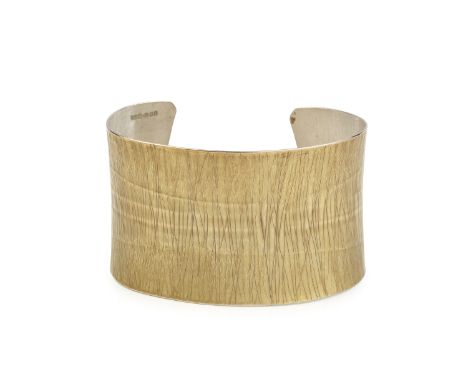 A silver cuff bangle, of slightly waisted form, with linear incised decoration, maker's mark J.A.A, width 6.8cmSurface wear, 