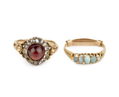 A garnet cluster ring, the circular cabochon garnet bordered by vari-cut diamonds and later replaced white stones, between sc