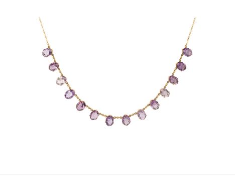 An amethyst fringe necklace, the trace-link chain suspending a line of graduated oval mixed-cut amethysts, the clasp stamped 
