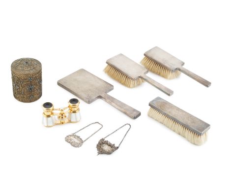 A silver backed four piece dressing table set, of engine turned rectangular design, comprising hand mirror, two hair brushes 